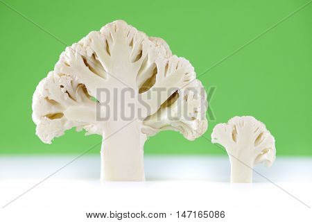 Cross section of cauliflower on green bacground