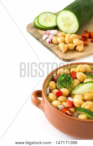 Chickpea salad in brown bowl isolated on white background