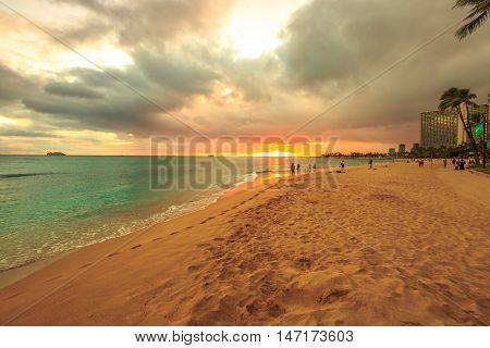 Waikiki, Oahu, Hawaii - August 20, 2016: twilight at Waikiki beach. Waikiki beach is a beautiful place to enjoy the sunset over the ocean.