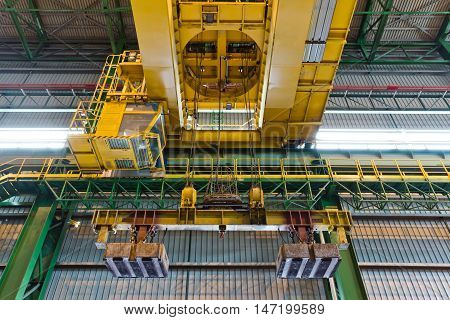 Crane with electrical magnet lift equipment at the metallurgical plant