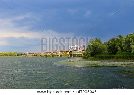 Bridge across river Dnieper in Kremenchug and storm clouds in sky