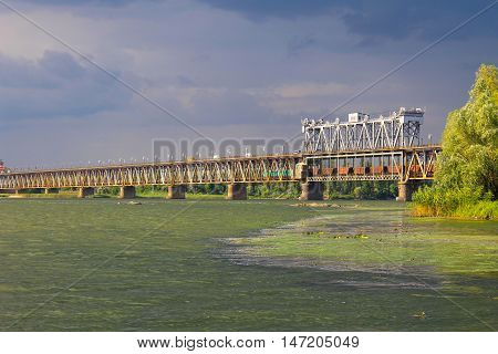 Bridge across river Dnieper in Kremenchug and storm clouds in sky