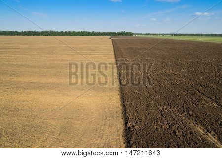KRASNODAR REGION, RUSSIA - AUG 19, 2015: Modern green tractor plows field after harvest, In 2015 in Krasnodar region yields reached record level - 58.4 centners per hectare