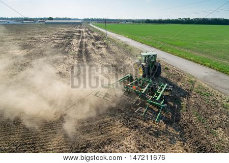 KRASNODAR REGION, RUSSIA - AUG 19, 2015: Modern tractor plows field after harvesting, In 2015 in Krasnodar region yields reached record level - 58.4 centners per hectar