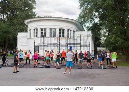 MOSCOW, RUSSIA - 31 JUL, 2015: Many athletes in the group training outdoor at City beach Port at ENEA.