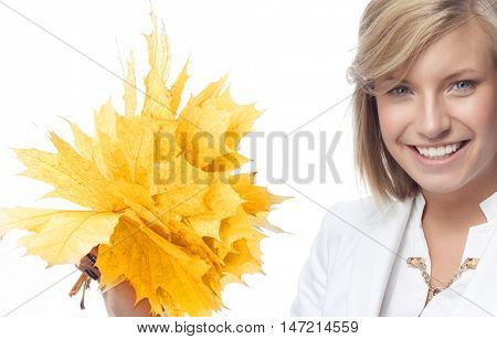 portrait of attractive  caucasian smiling woman isolated on white studio shot looking at camera hand holding yellow marple autumn leaves