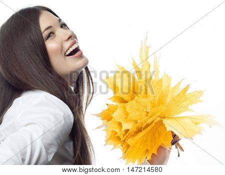 closeup portrait of attractive  caucasian smiling woman brunette isolated on white studio shot lips toothy smile face hair head and shoulders looking up tooth hand holding yellow marple autumn leaves
