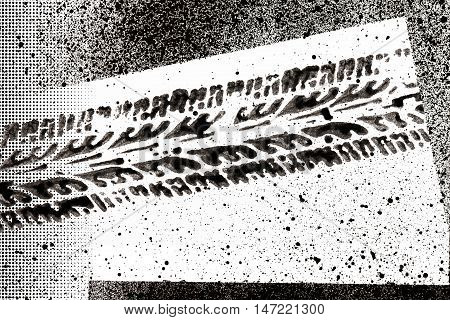 tire track made with ink and other design elements on white