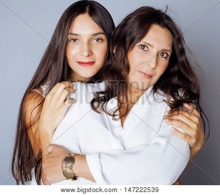 cute pretty teen daughter with mature mothr hugging, fashion style brunette 