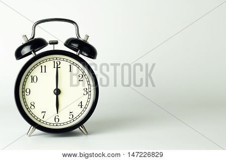 Alarm Clock isolated on white showing six o'clock.