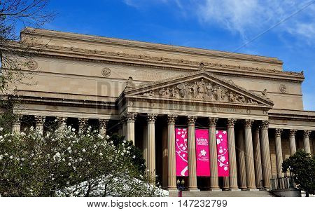 Washington DC - April 11 2014: The classical facade and ornate tympanum bas reliefs of the 1837 Archives of the United States building on Constitution Avenue *