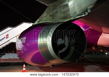 Kiev Ukraine - March 27 2011: Wizz Air Airbus A320 engine closeup - plane is parked on the apron at night