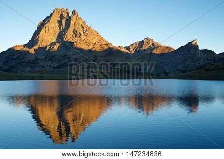 Midi Dossau Peak reflected in Ayous lake. Ossau Valley, Pyrenees National Park, Pyrenees, France.
