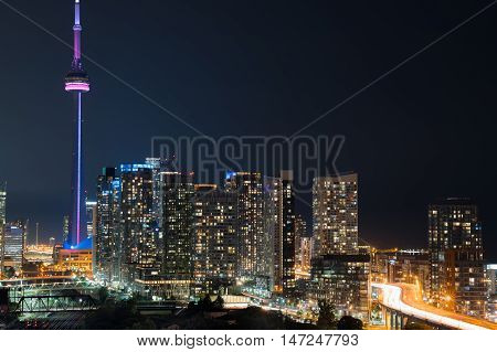 Glowing light streaks from Gardiner Expressway as traffic  never stops.  Hot & muggy summer night in Lakeside 
Toronto, Canada.