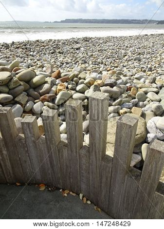 Wooden fence edged Rocky beach seascape photographed at Amroth in Pembrokeshire