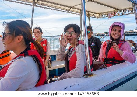 Semporna,Sabah-Sept 10,2016:Happy tourists on the speedboat at Semporna on 10th Sept 2016.Semporna is a gateway for diving & snorkeling trips to the islands of Sipadan,Mabul,Mataking,Maiga & others