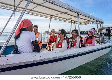 Semporna,Sabah-Sept 10,2016:Happy tourists on the speedboat at Semporna on 10th Sept 2016.Semporna is a gateway for diving & snorkeling trips to the islands of Sipadan,Mabul,Mataking,Maiga & others