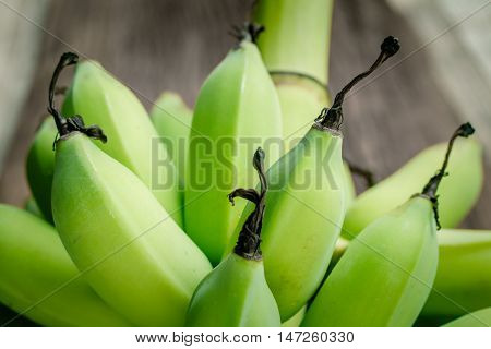raw bananas green on a wooden background