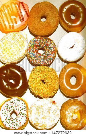 Variety of doughnuts in cardboard box, view from above