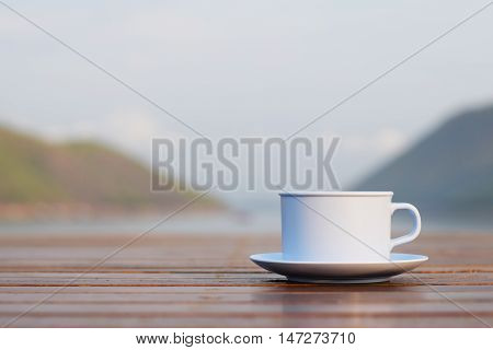 Coffee cup with river and mountain (vintage background)