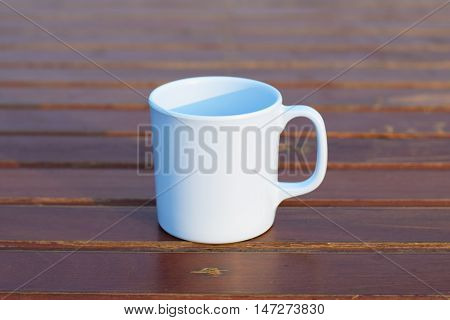 Coffee cup on wooden table (vintage background)