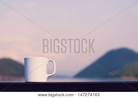 Coffee cup with river and mountain (vintage background)