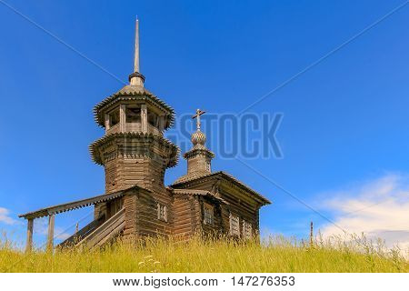 Old wooden Church in the village in the summer