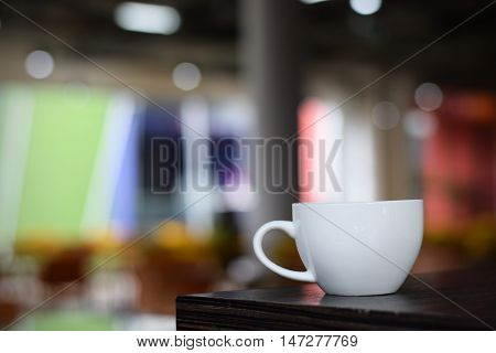 Coffee cup on table in cafe (vintage background)
