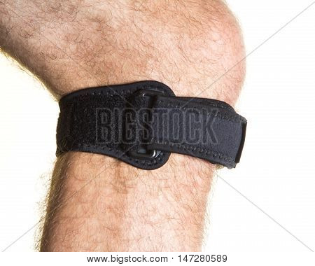 Bandage For The Knee Cap With Pressure Regulator On The Male Leg - Isolate