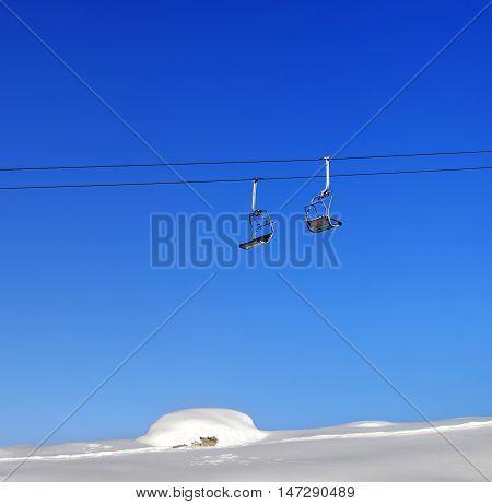 Chair-lift And Blue Clear Sky At Sunny Day