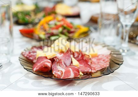 Meat cold cuts on a banquet table. shallow depth of field