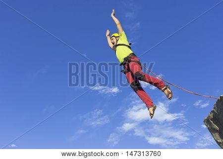 The first jump off the cliff with a safety rope.