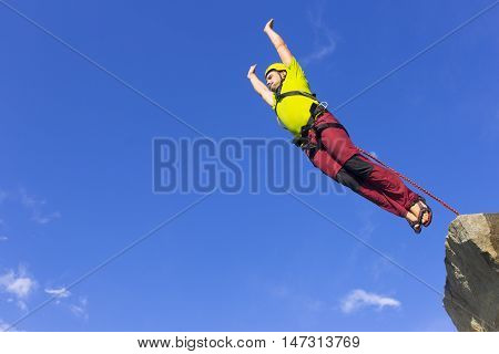 The first jump off the cliff with a safety rope.