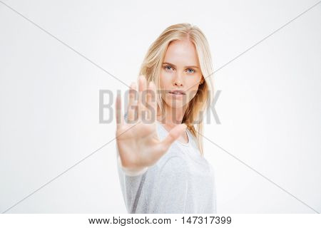 Portrait of a beautiful girl showing stop sign with palm isolated on a white background