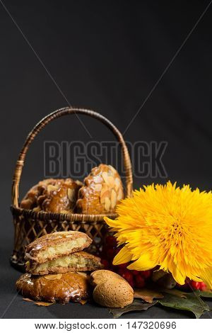 Typical Dutch filled spicy cookies with almonds on autumn colored and dark background