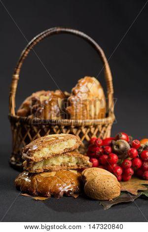 Typical Dutch filled spicy cookies with almonds on autumn colored and dark background