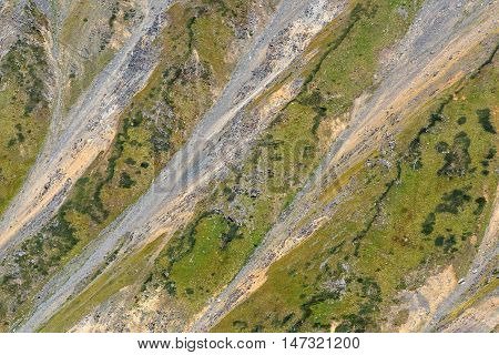 Bright beautiful abstract natural background of the mountain with fissure talus and sparse vegetation