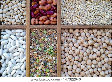 Collection assorted of lentils beans peas grain groats soybeans legumes in wooden box