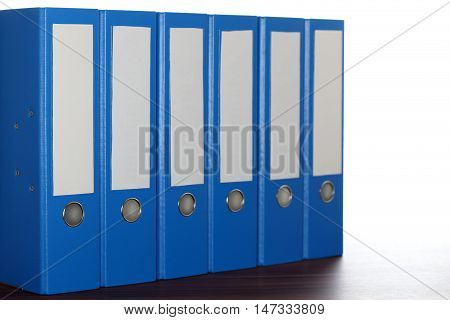 six file folders in a row in office