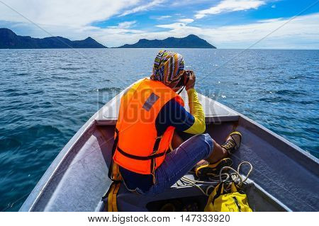 Semporna,Sabah-Sep 10,2016:Unidentified professional photographer using a professional DSLR camera at Semporna,Sabah.Semporna is surrounded by white sand & the turquoise waters of the Celebes Sea.