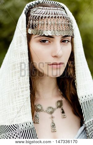 Young girl in traditional folk Crimean Tatar clothes walking in fields