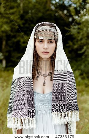Young girl in traditional folk Crimean Tatar clothes walking in fields