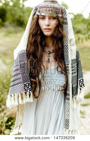 Young girl in traditional folk Crimean Tatar clothes walking in fields