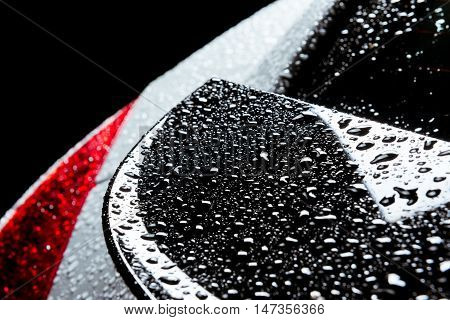 Closeup photo of the rain water drops on smooth car body
