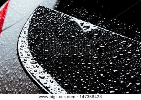 Closeup photo of the rain water drops on smooth car body