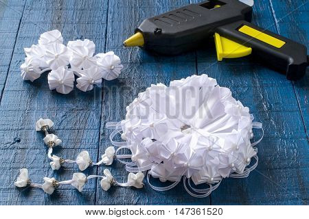 Making beautiful bows for decoration hair and gifts in the art kanzashi. Step by step photo instructions. Step 5. Making a bow with pendants of the details in the shape of a flower with bead