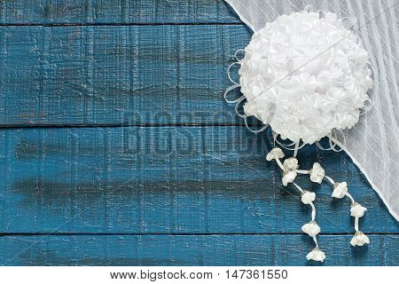Homemade beautiful bow with pendants in the art kanzashi for decoration gifts on a blue wooden background with space for text