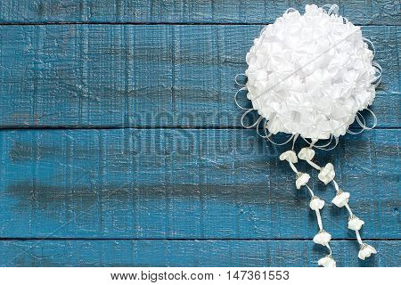 Homemade beautiful bow with pendants in the art kanzashi for decoration gifts on a blue wooden background with space for text