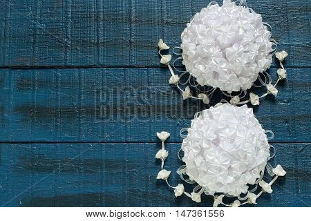 Homemade beautiful bow with pendants in the art kanzashi for decoration gifts on a blue wooden background with space for text