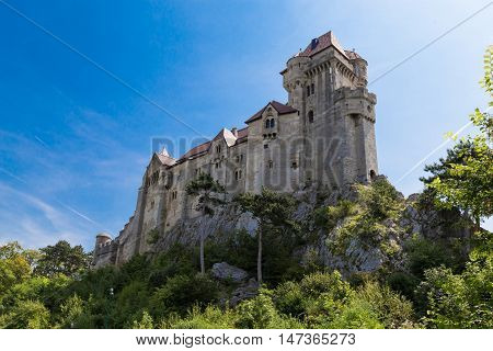 Ancient castle Liechtenstein Vienna woods village Maria Enzersdorf Austria - against bright blue sky